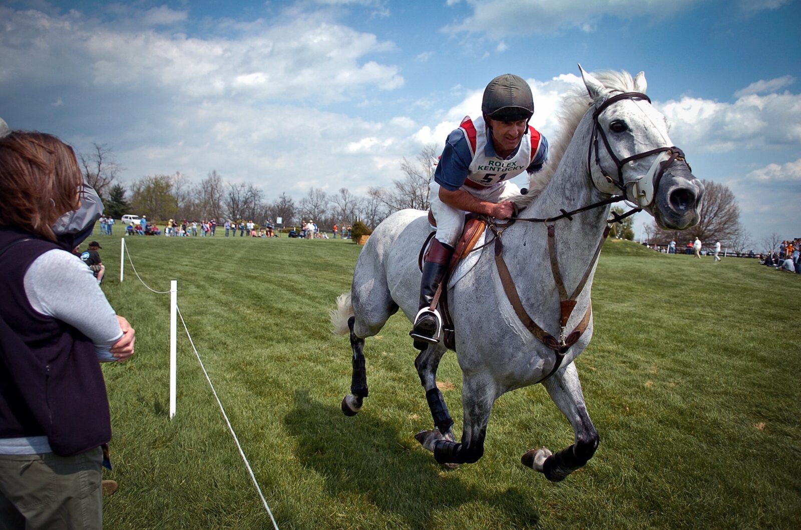 A man riding a gray horse